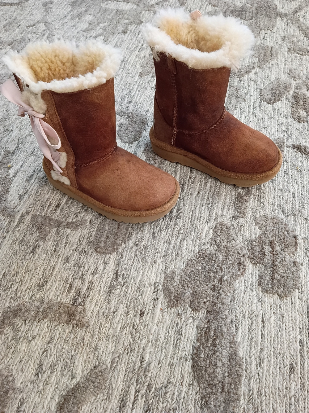 UGG Kids Chestnut Brown Sheepskin Boots with Pink Ribbon